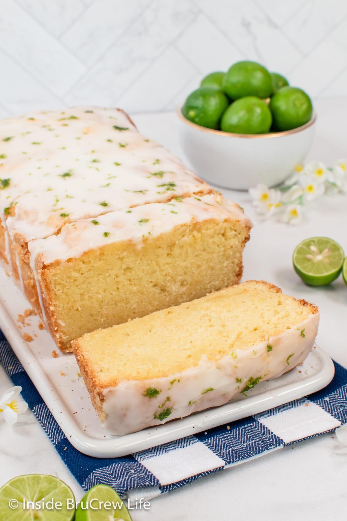 Glazed pound cake on a white plate.