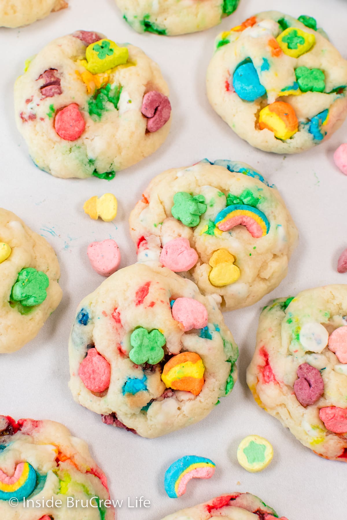 A white board with Lucky Charms cookies lying on it.