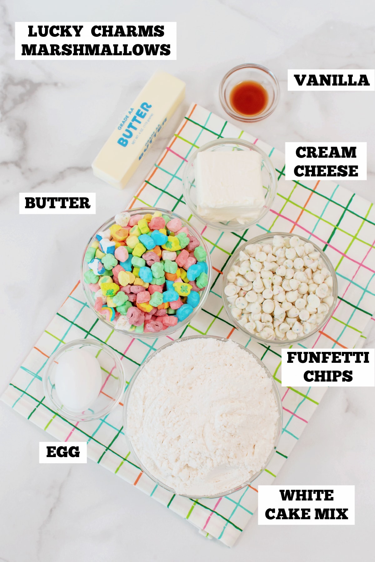 A white board with bowls of ingredients to make cake mix cookies with marshmallows.
