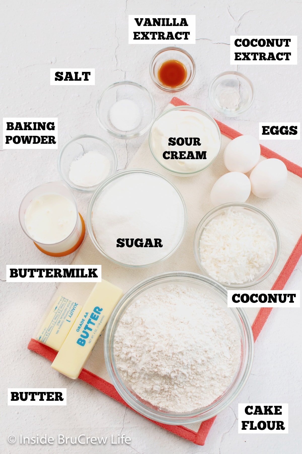 A white board with bowls of ingredient needed to make a homemade cake.
