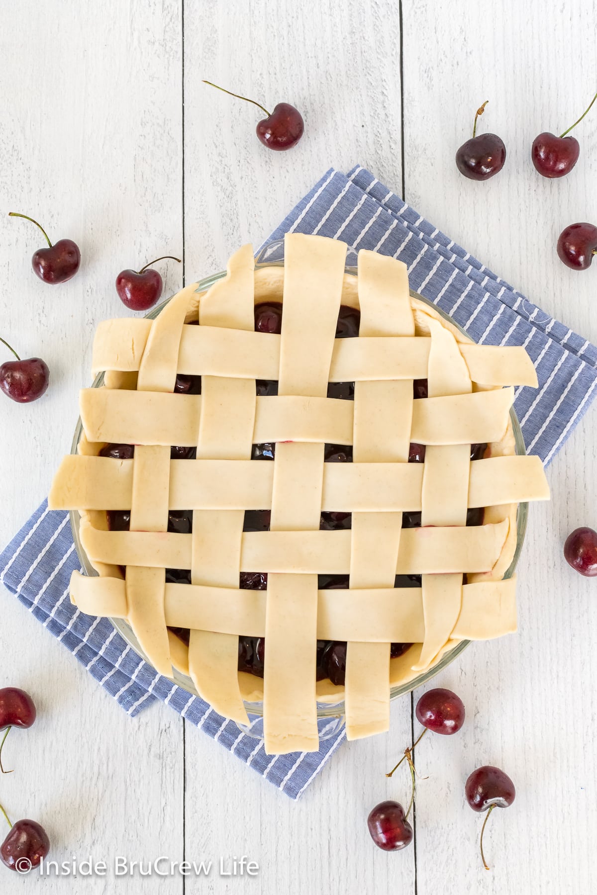 A pie with a lattice top dough covering it.