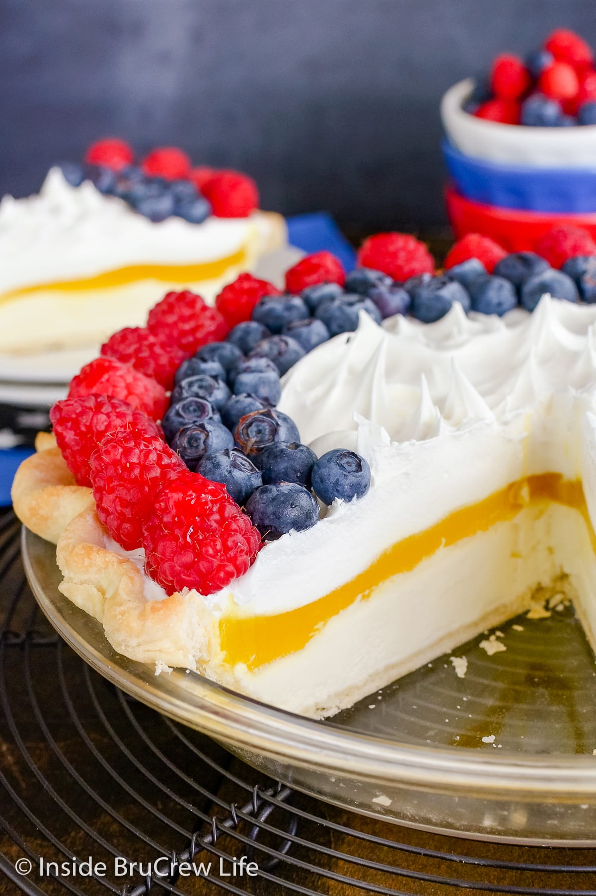 A lemon cream pie topped with fresh berries.