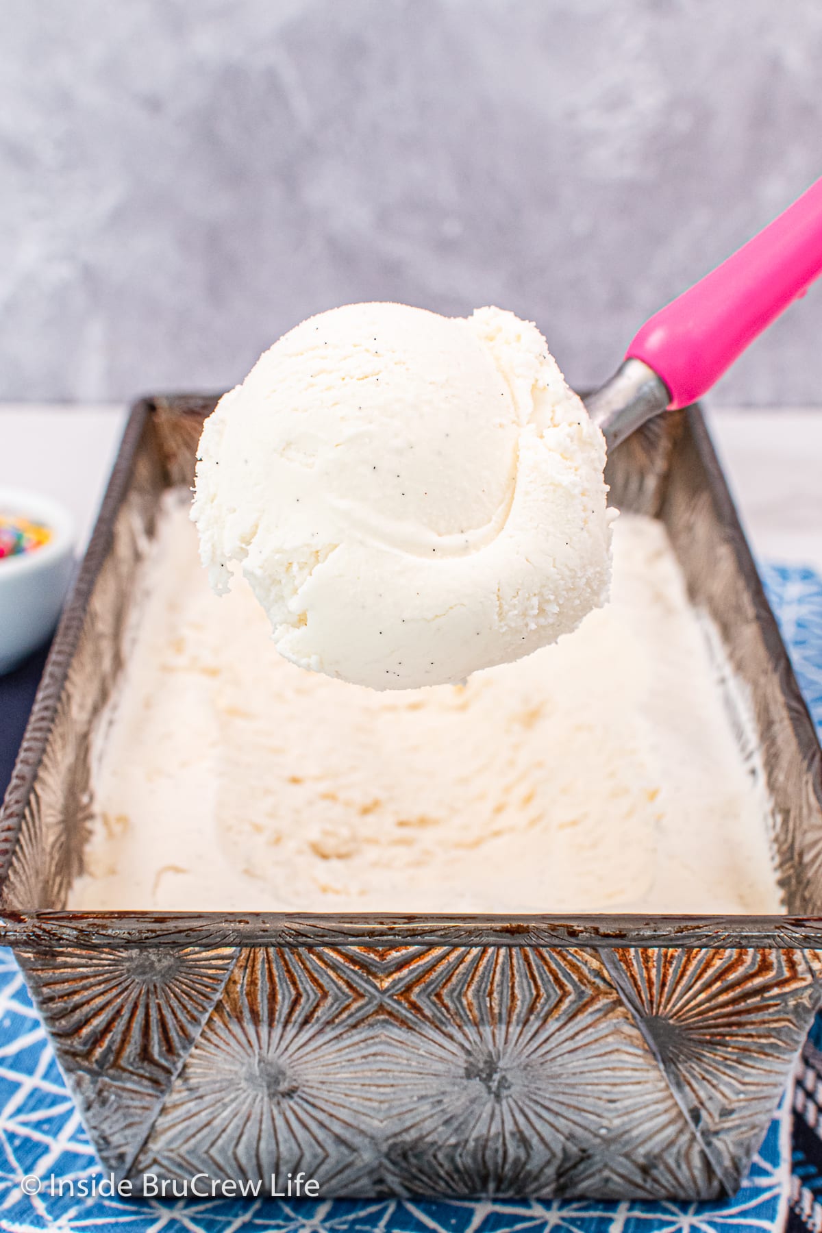 A scoop of ice cream being lifted out of a pan.