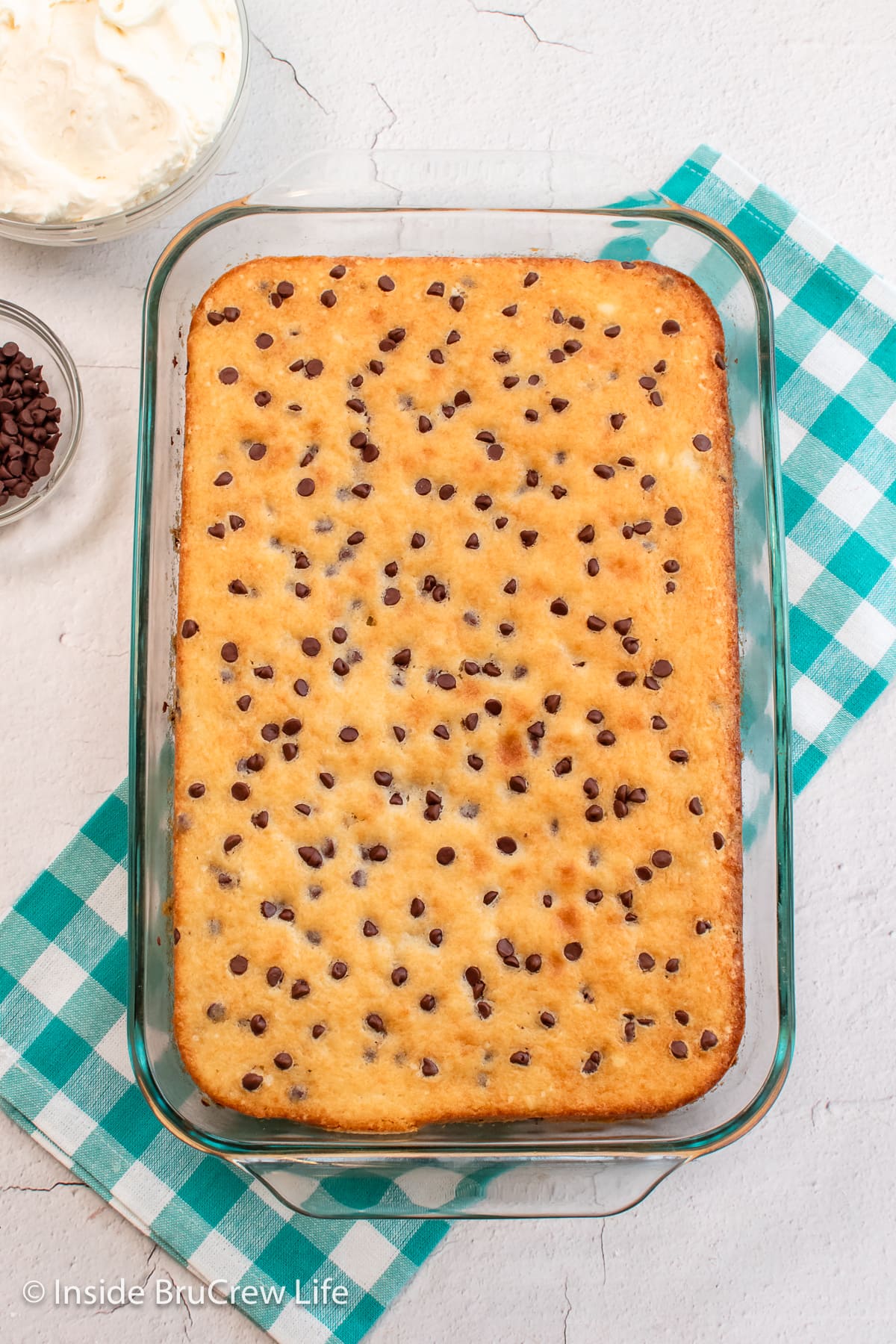 A finished cake topped with chocolate chips.