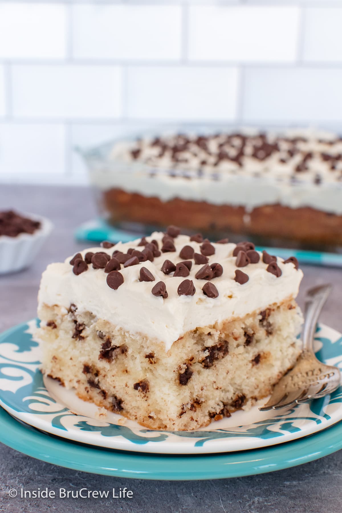 A slice of cake with frosting on a plate.