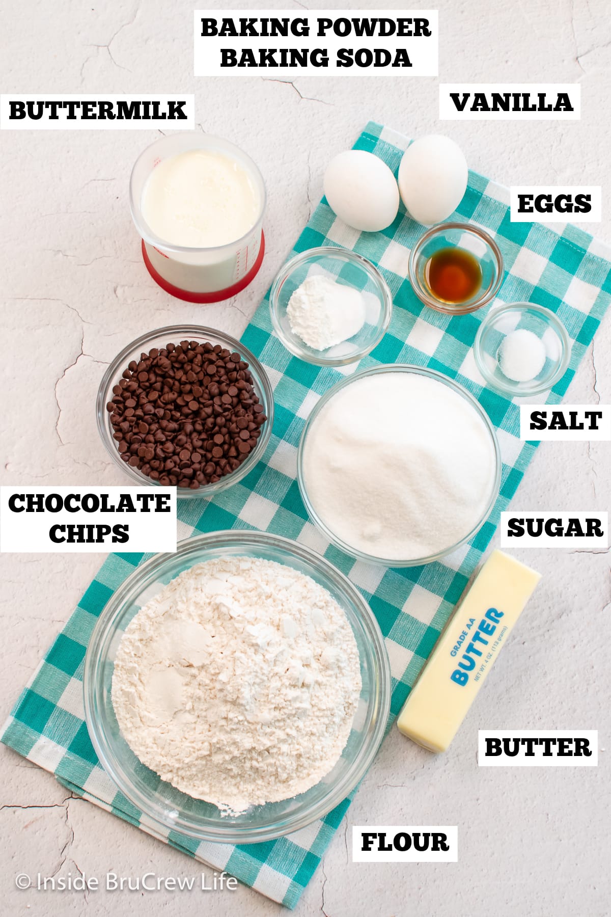 A white board with bowls of ingredients needed to make a homemade cake.
