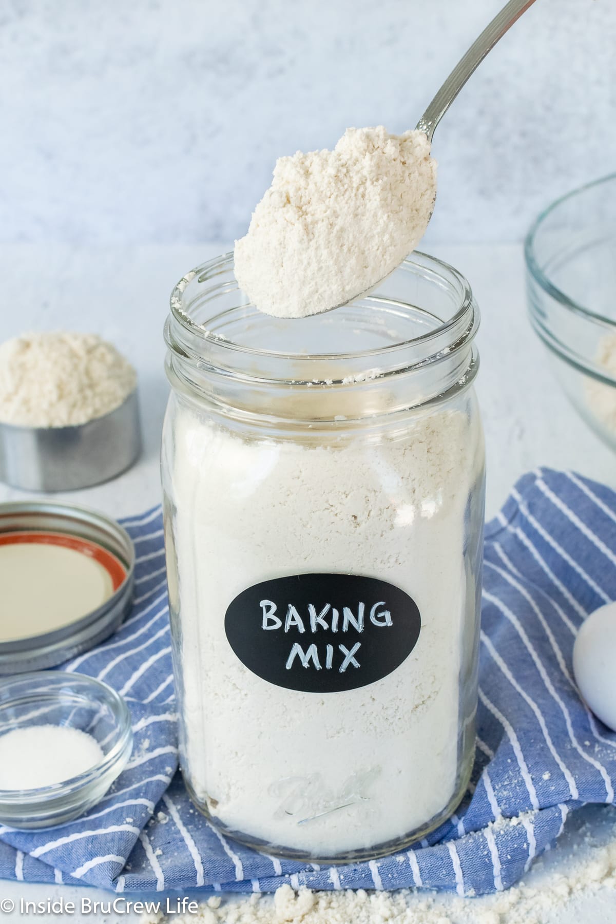 A mason jar of homemade baking mix with a spoon in it.