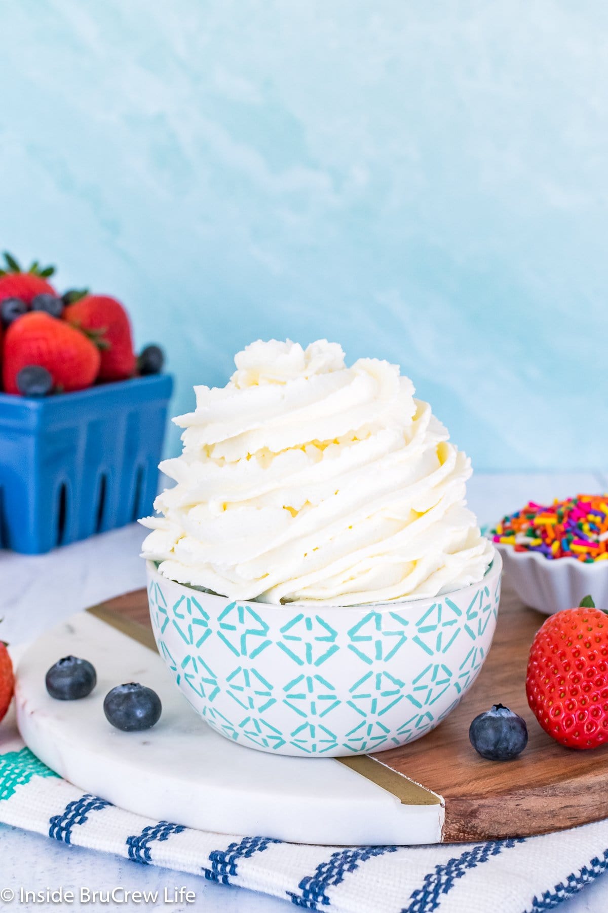 A white and teal bowl filled with whipped topping.