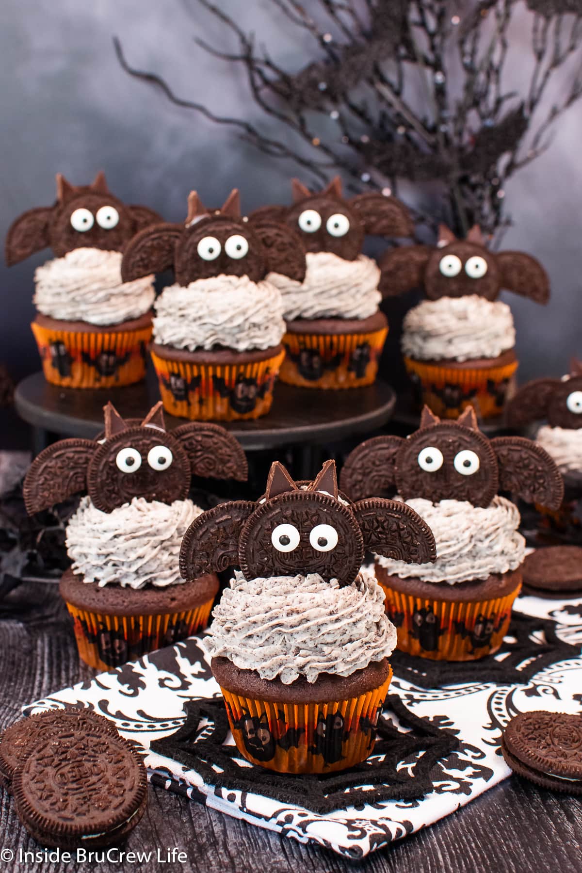 Cupcakes topped with Oreo cookies that look like bats.