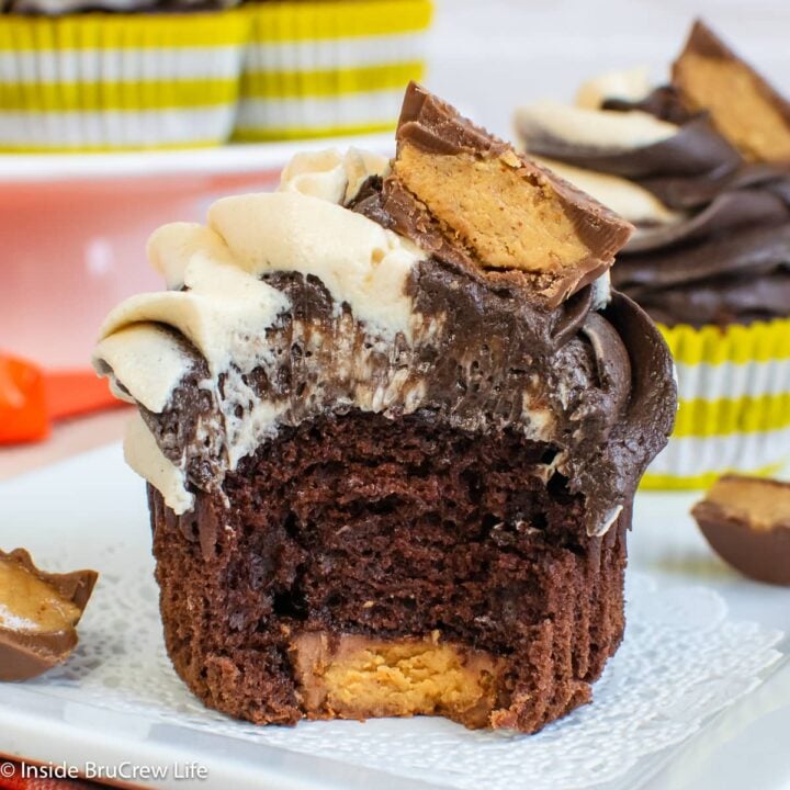 A chocolate cupcake with a peanut butter cup on the bottom.