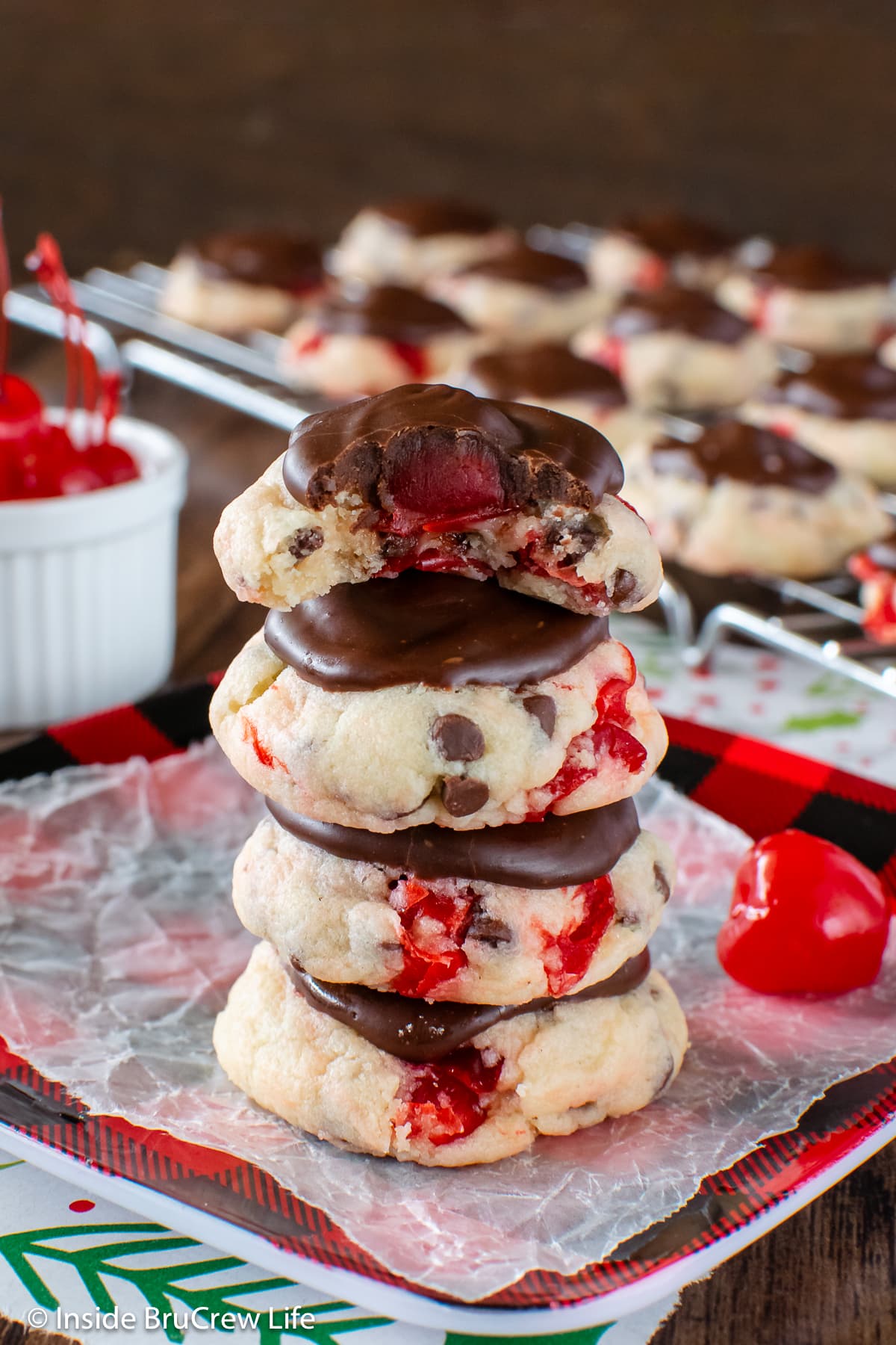 A stack of chocolate covered cookies on a plate.