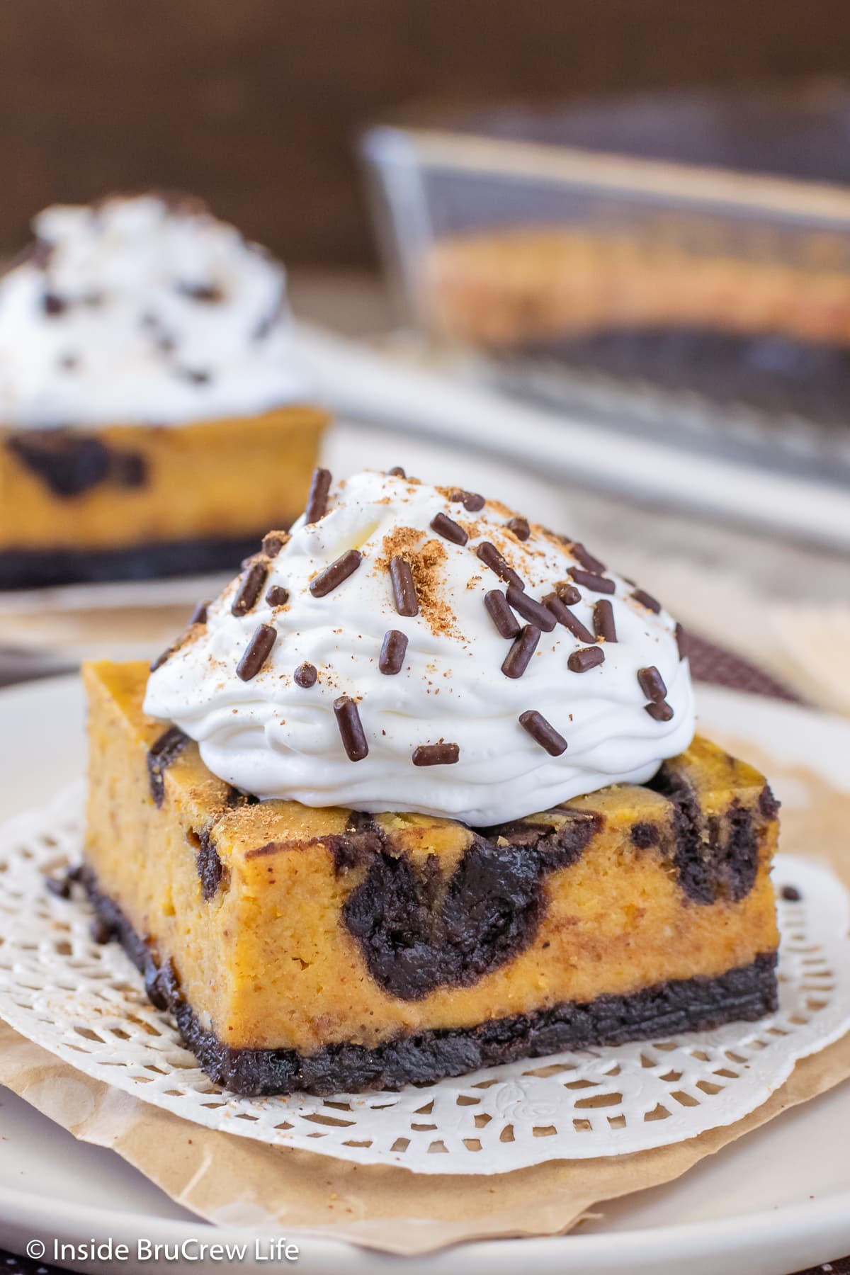A pumpkin cheesecake brownie topped with Cool Whip.