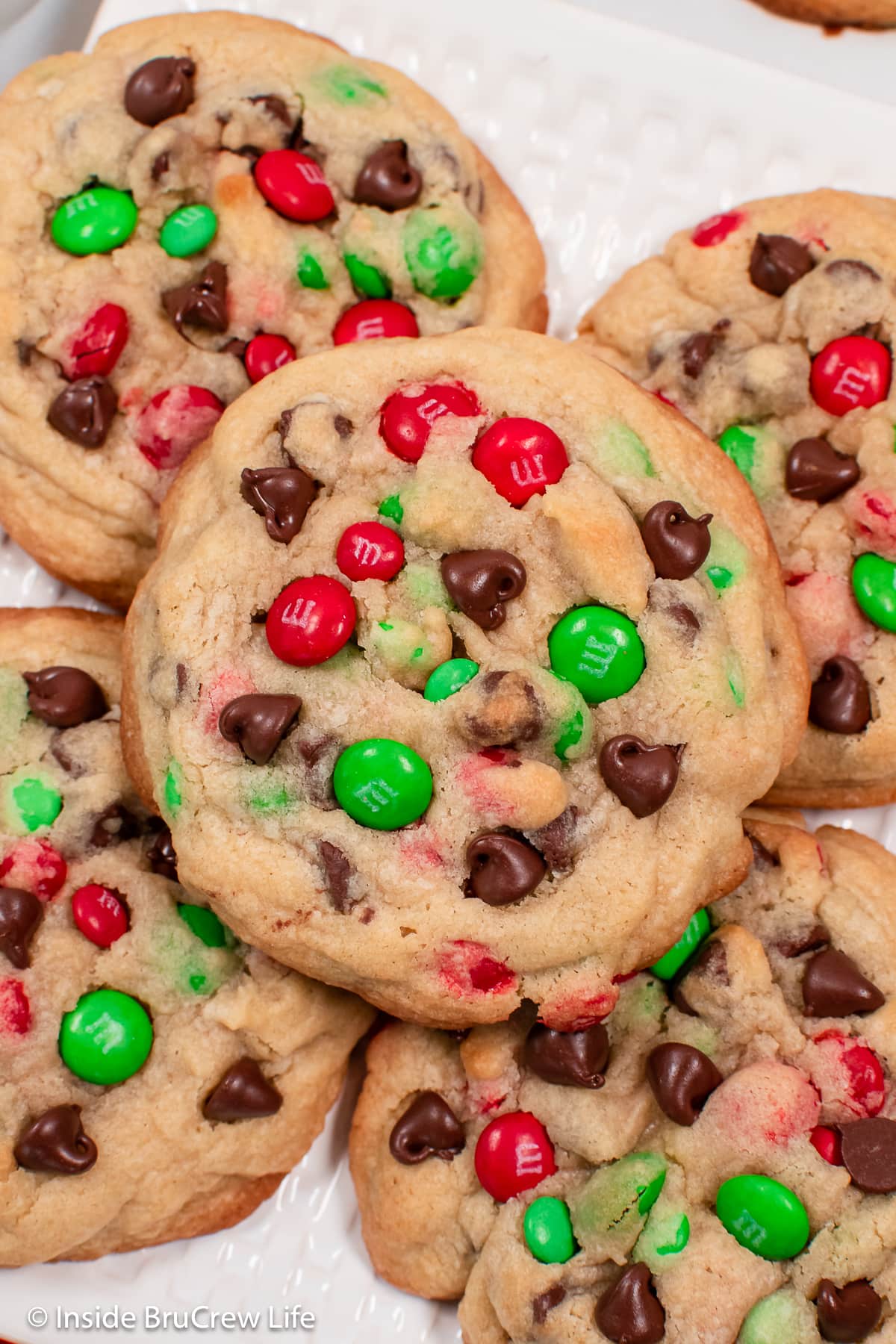 A close up of a holiday cookie with red and green candies.