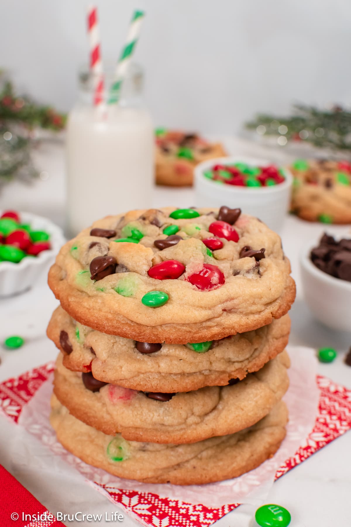 A stack of cookies with red and green candies in them.