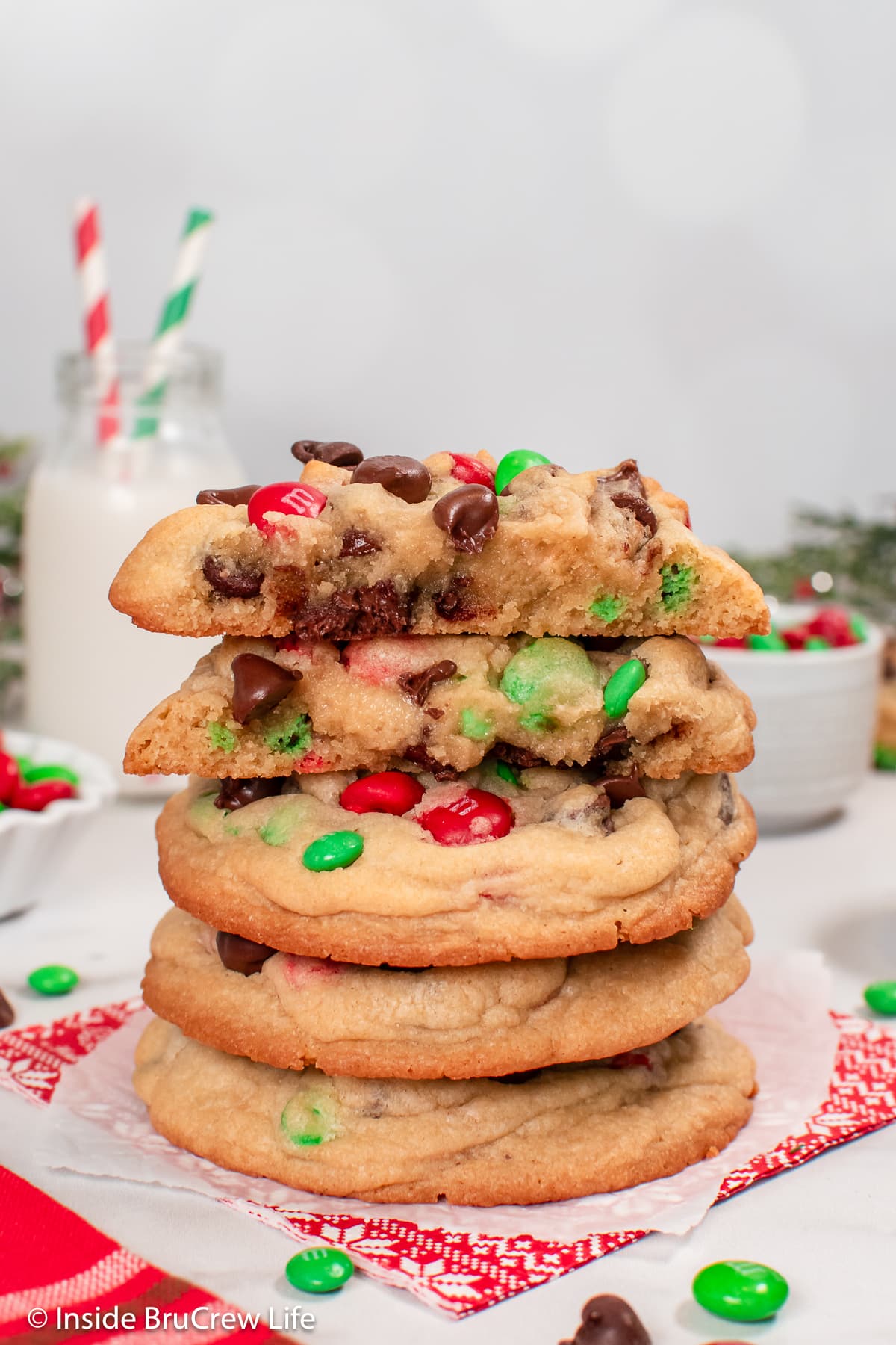 A stack of cookies with one broken in half on the top.