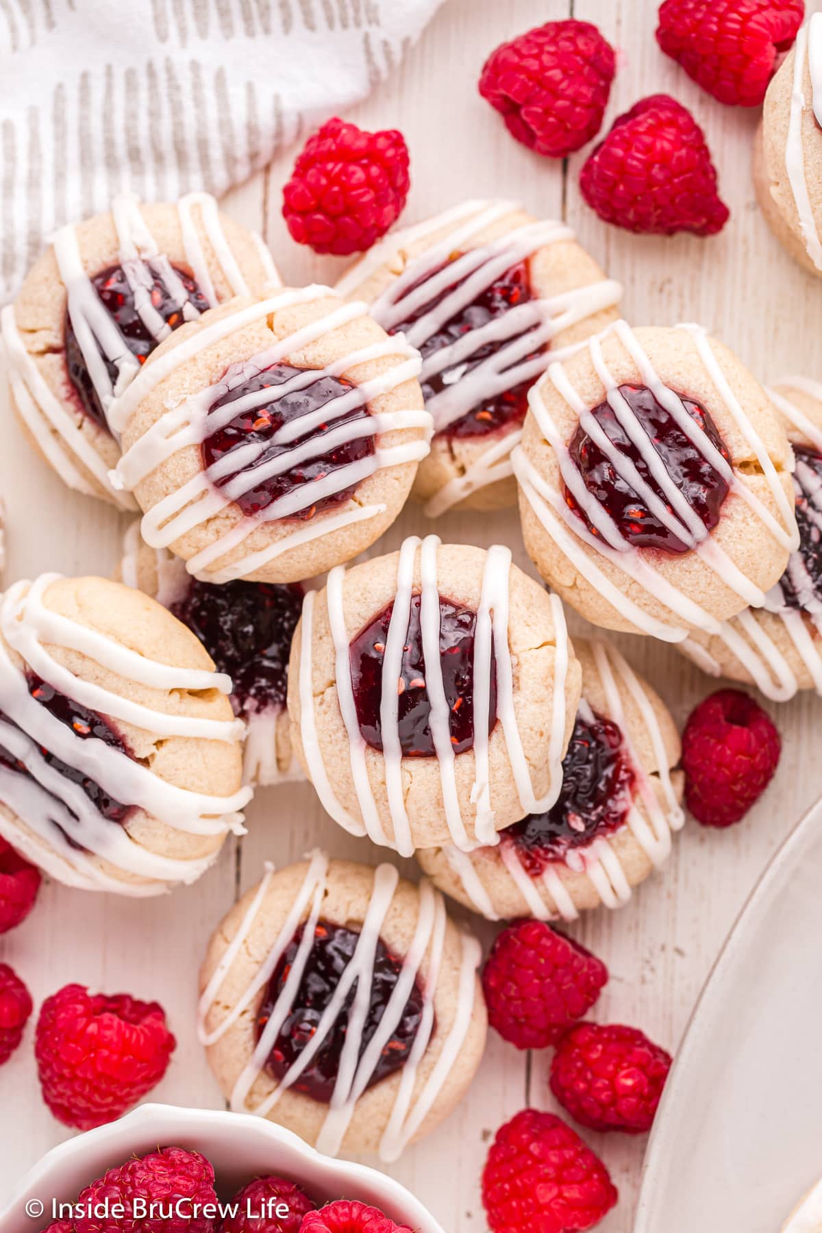 Raspberry filled shortbread cookies on a tray.