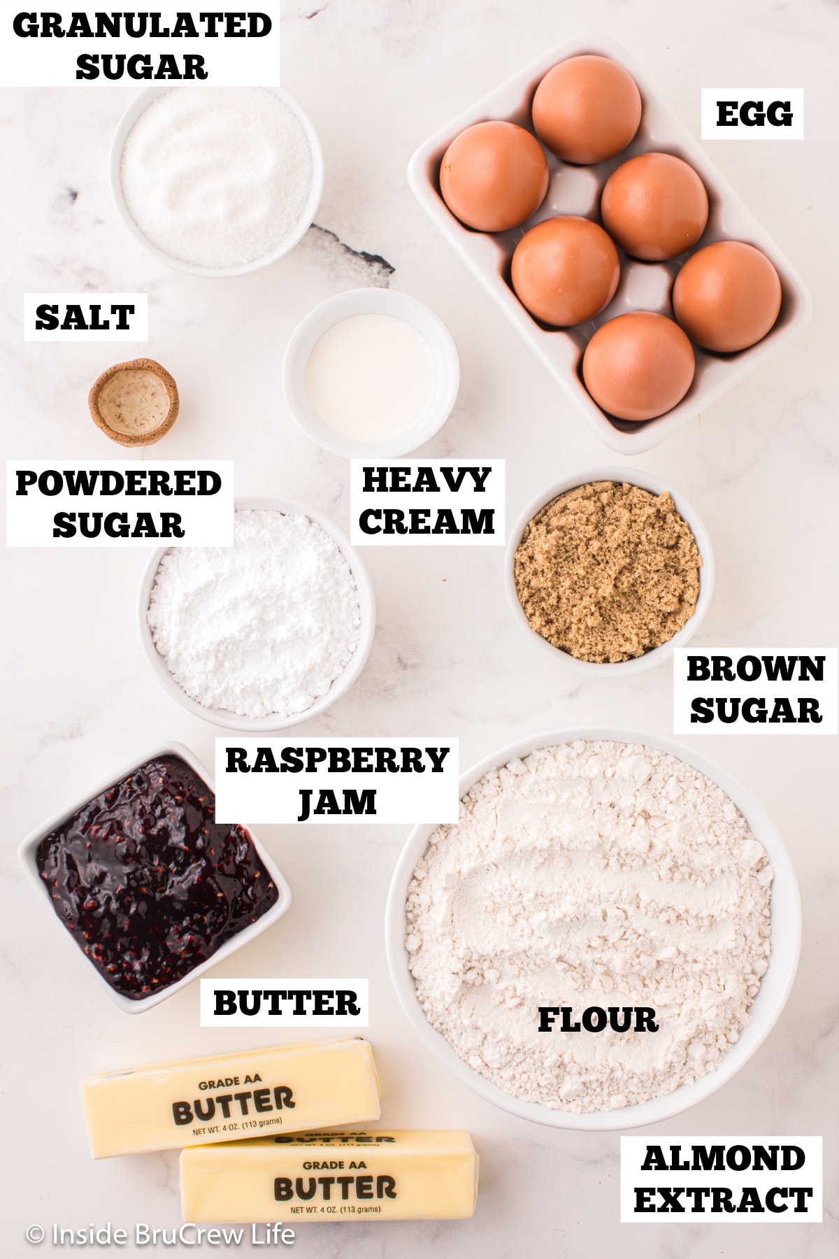 A white board with ingredients needed to make cookies with jam.