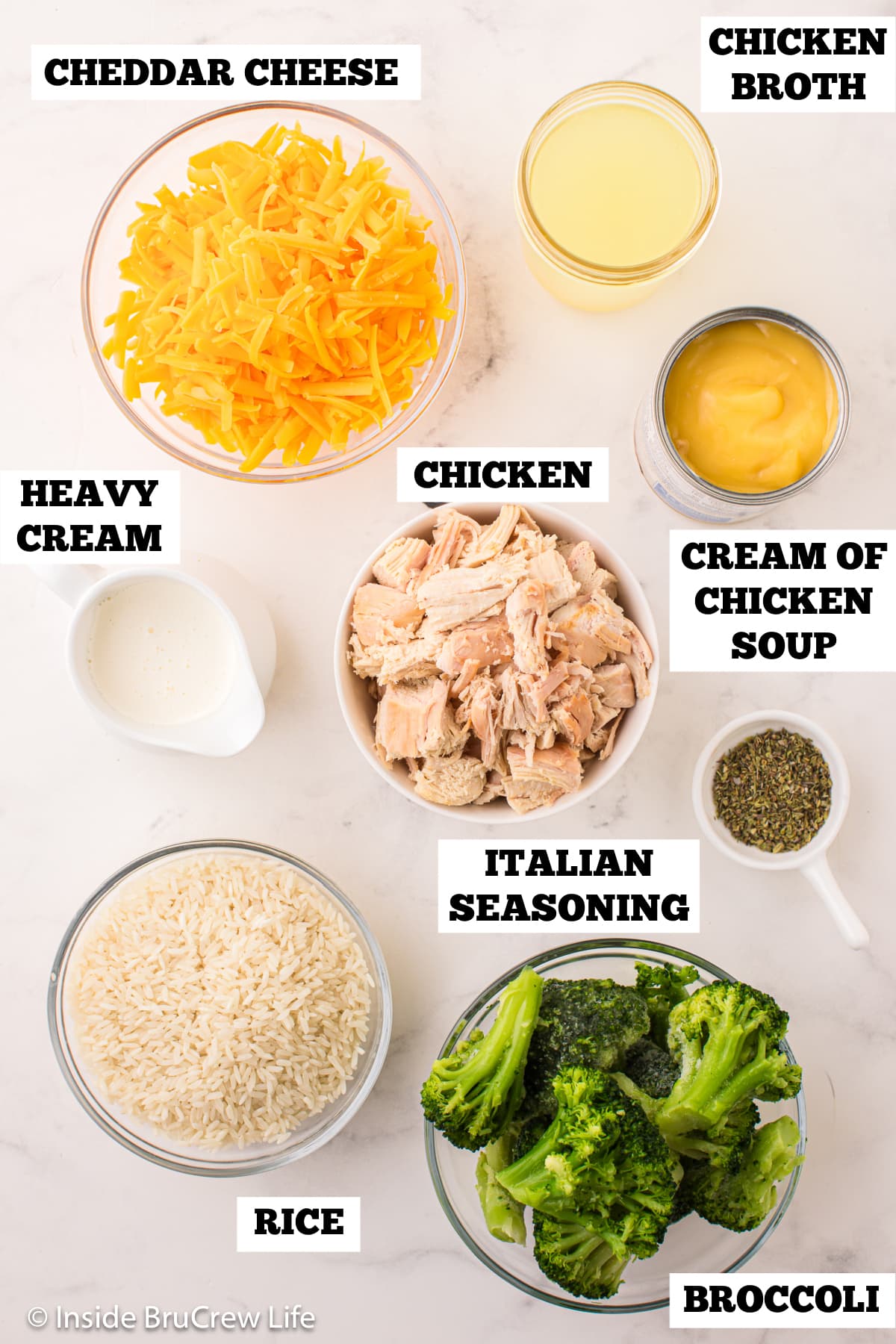 A white board with bowls of ingredients needed to make a rice casserole.