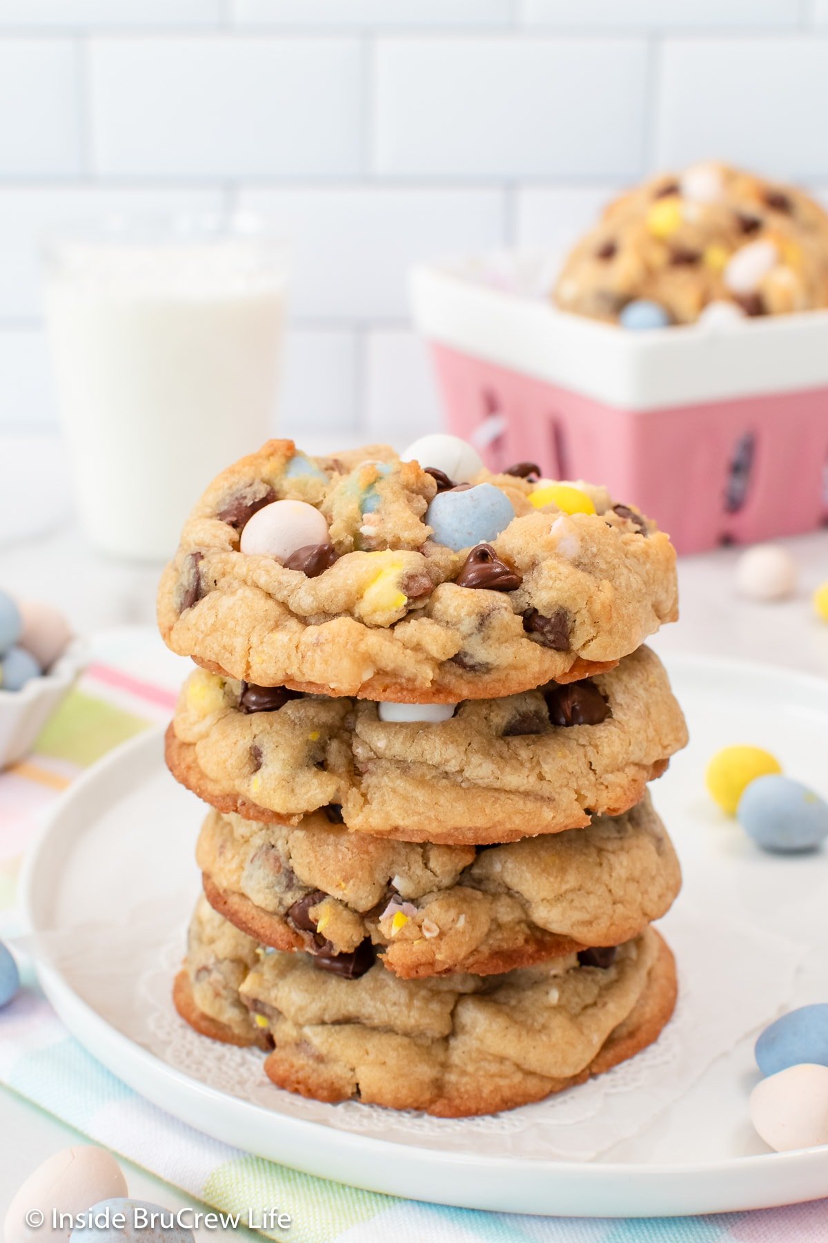 A stack of four candy loaded chocolate chip cookies.