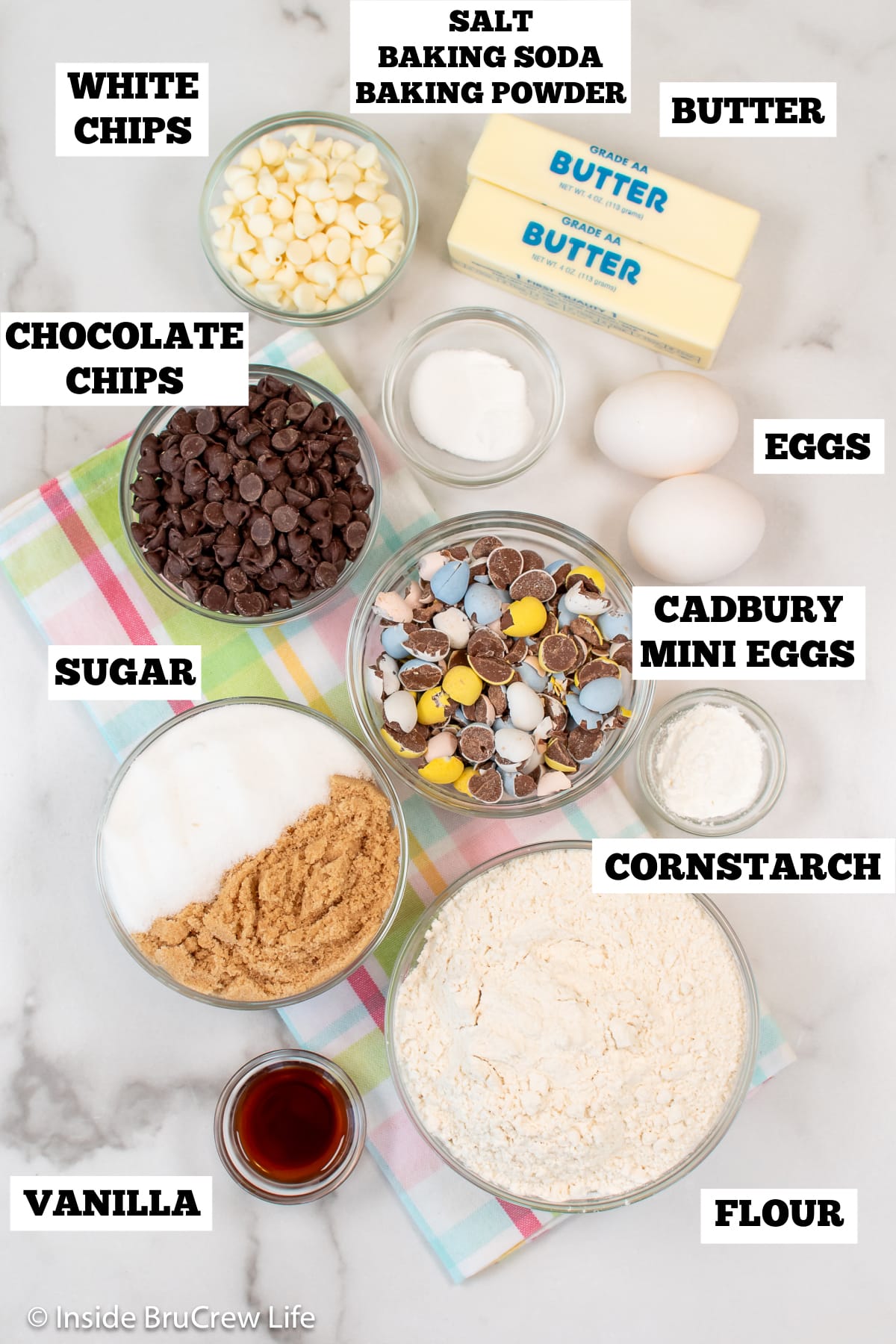 Bowls of ingredients needed to make chocolate chip cookies with cadbury mini eggs.