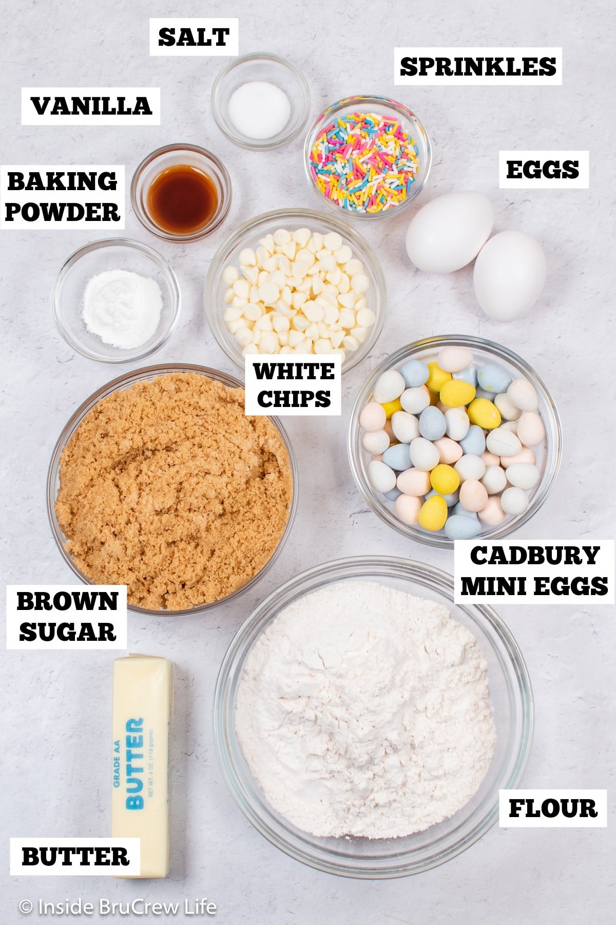 A white board with bowls of ingredients needed to make blondies.