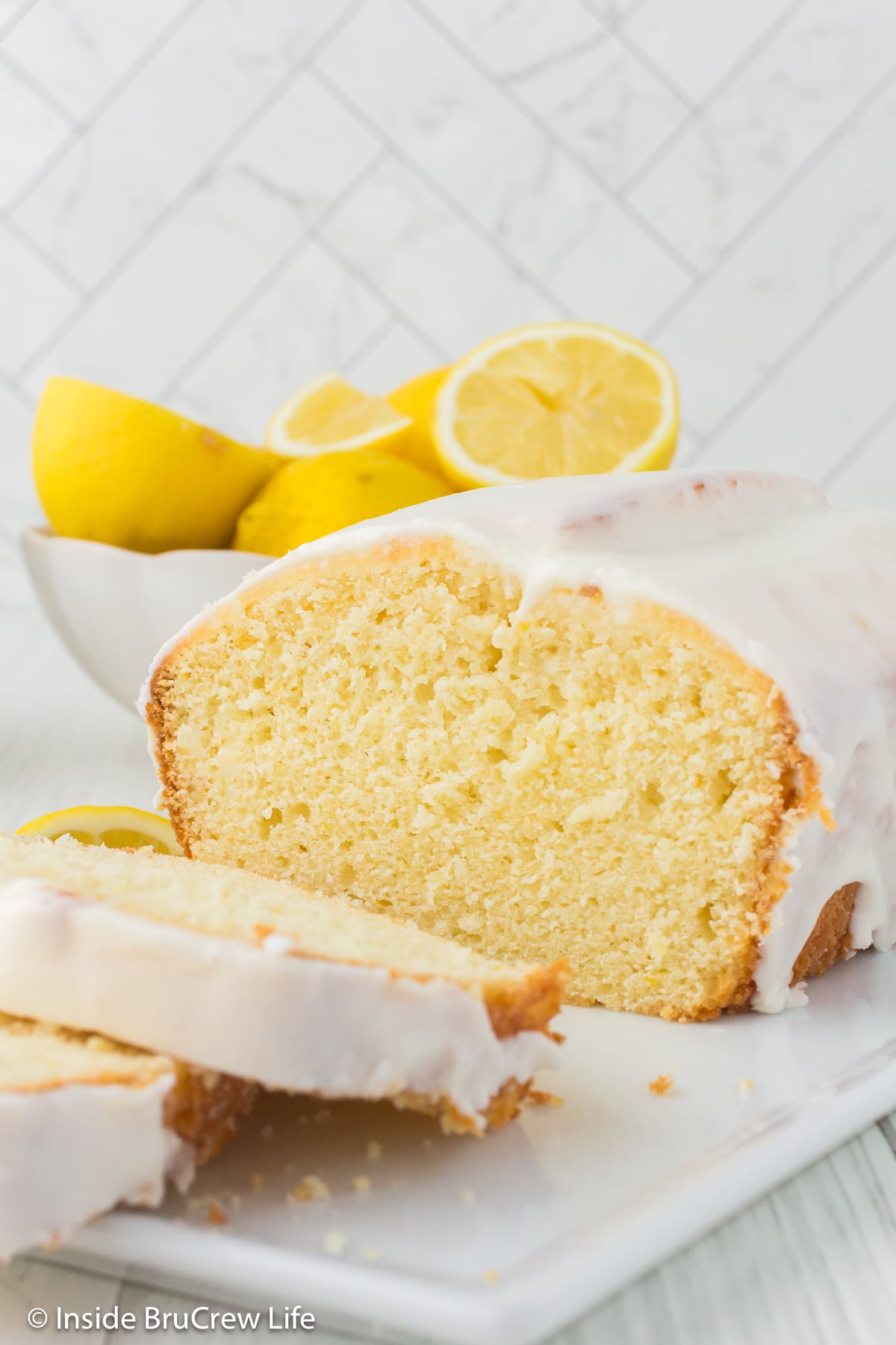 A loaf of lemon bread on a white tray.