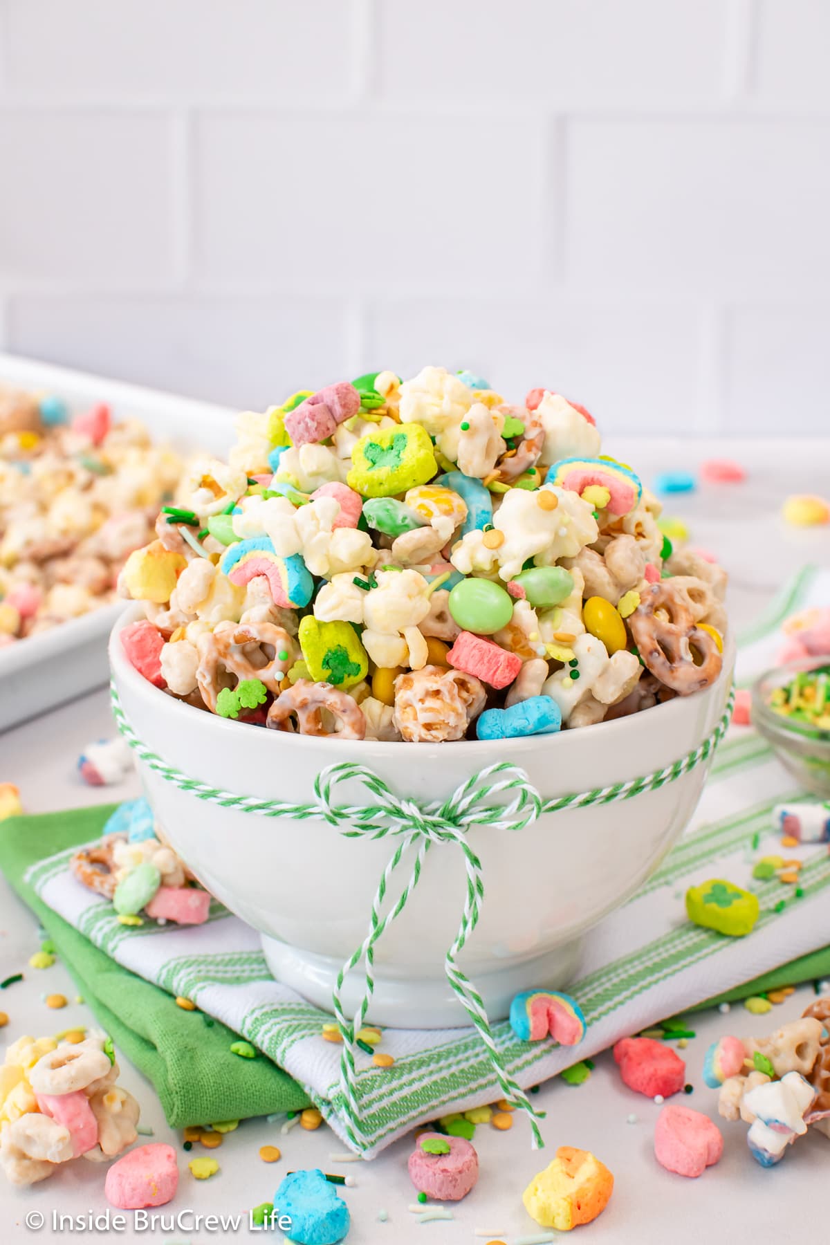 Lucky Charms snack mix piled high in a white bowl.