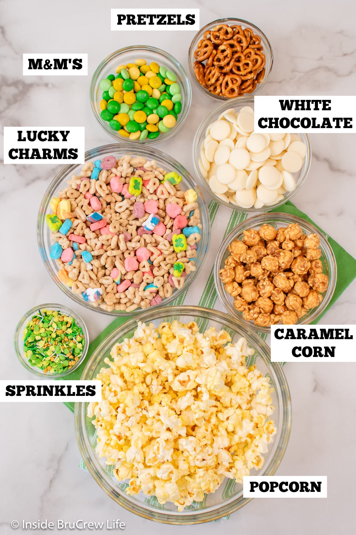 Bowls of ingredients to make chocolate covered popcorn.