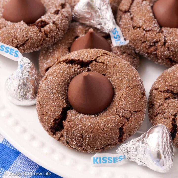 A white plate with chocolate kiss cookies on it.