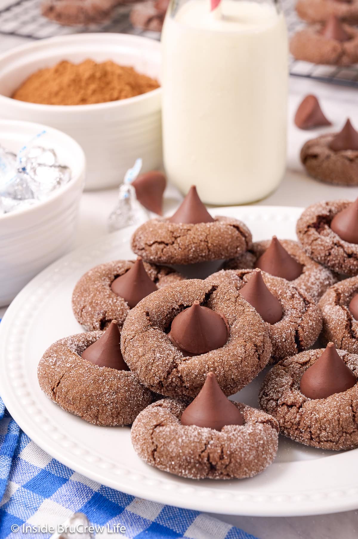 A white plate filled with chocolate kiss cookies.