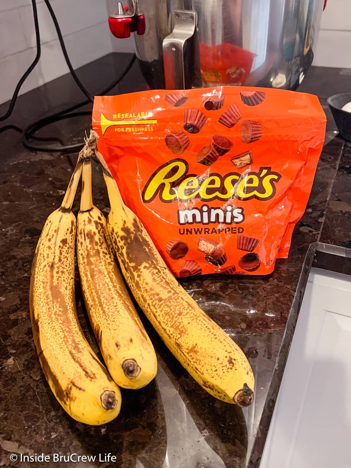 Bananas and peanut butter cups on a counter.