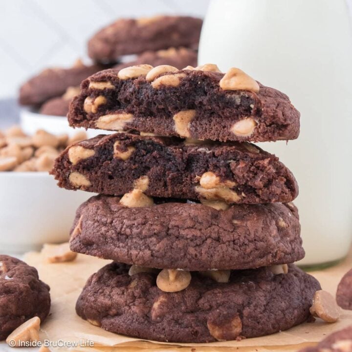 A stack of chocolate peanut butter chip cookies on a white board.