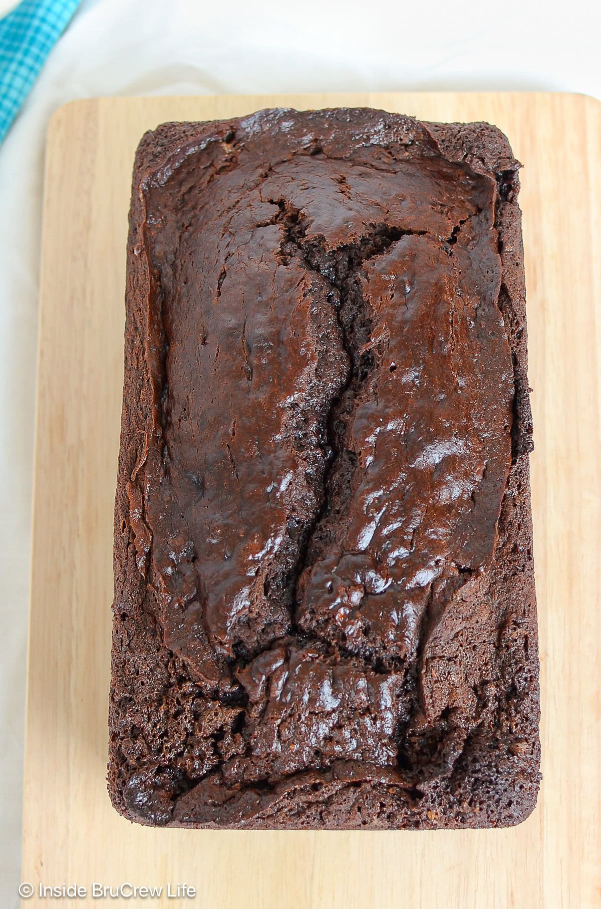 A loaf of chocolate mocha banana bread on a cutting board.