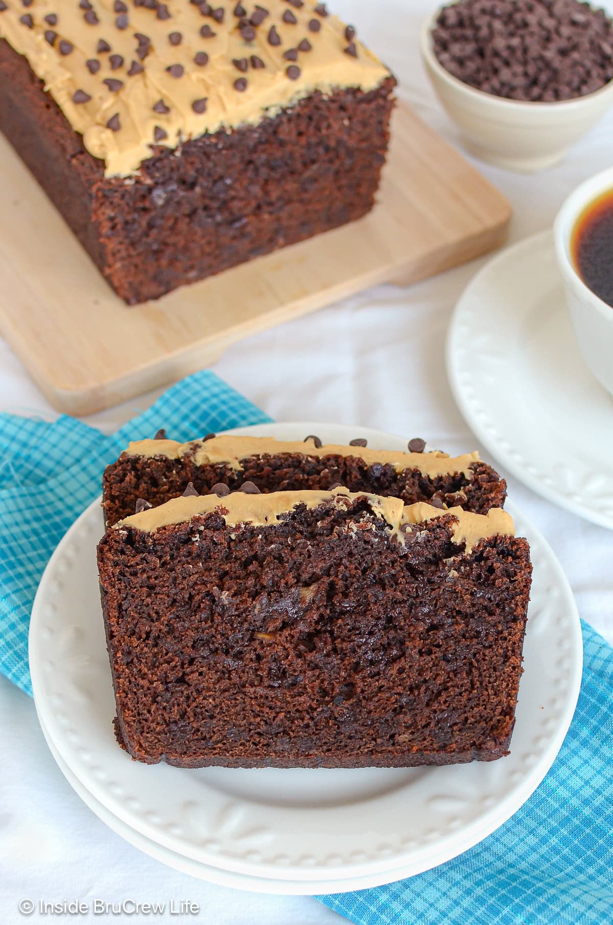 Two slices of chocolate sweet bread on a white plate.