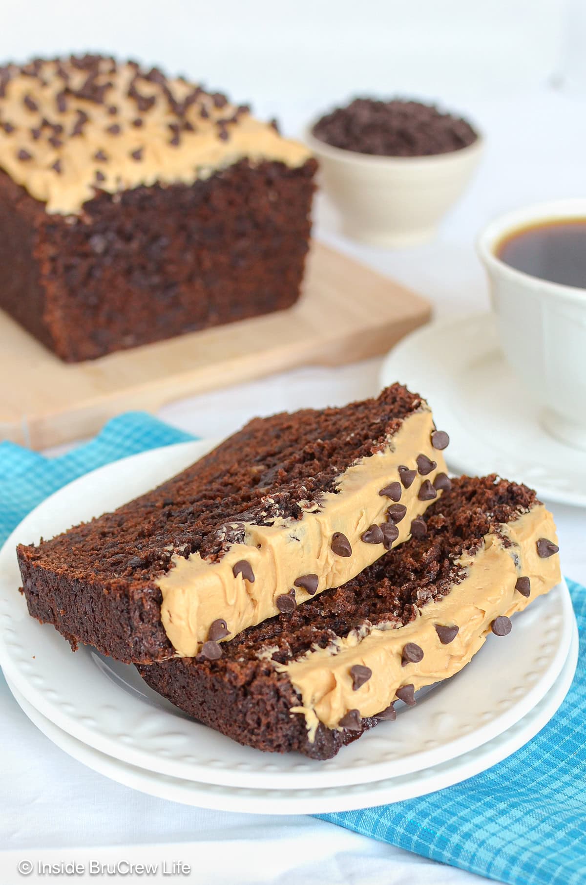 Two slices of mocha banana bread with chocolate chips on a white plate.