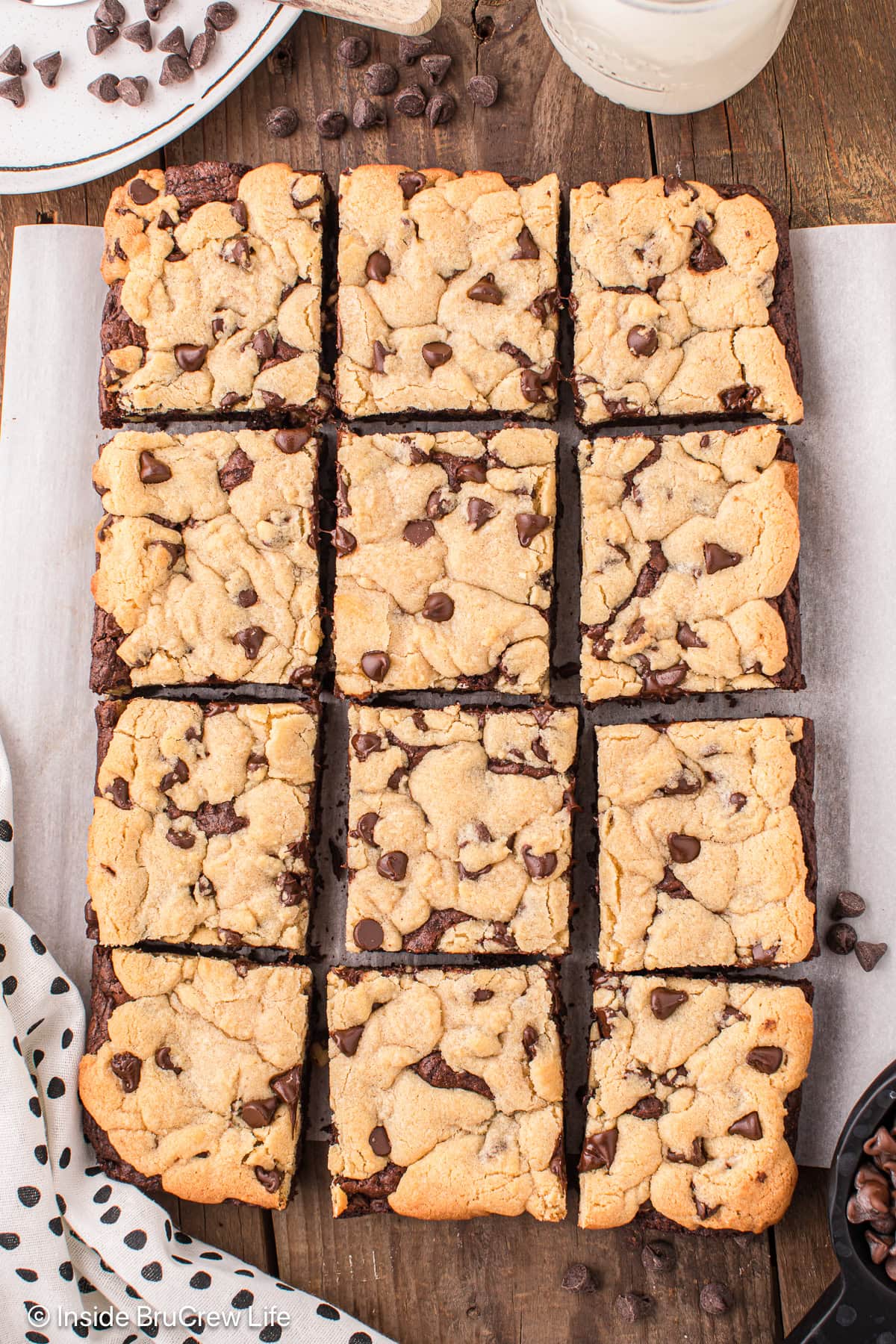 Brownie cookie squares lined up on a board.