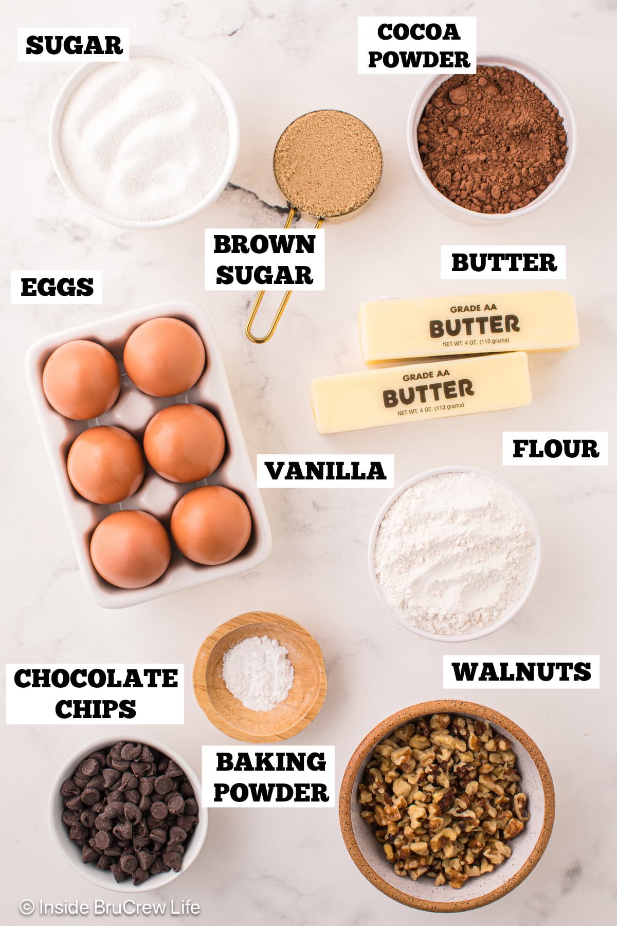 Bowls of ingredients needed to make cookie and brownie layers.