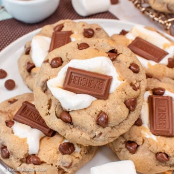 A white plate stacked with s'mores chocolate chip cookies.