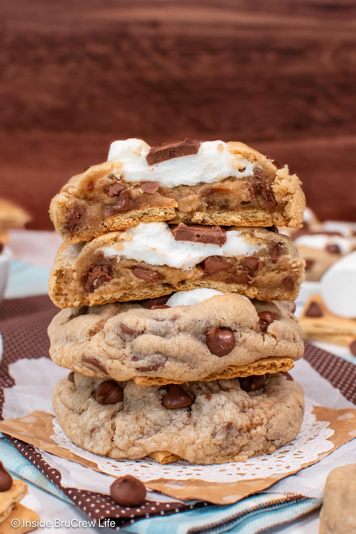 A stack of s'mores cookies with one cut in half showing the gooey center.