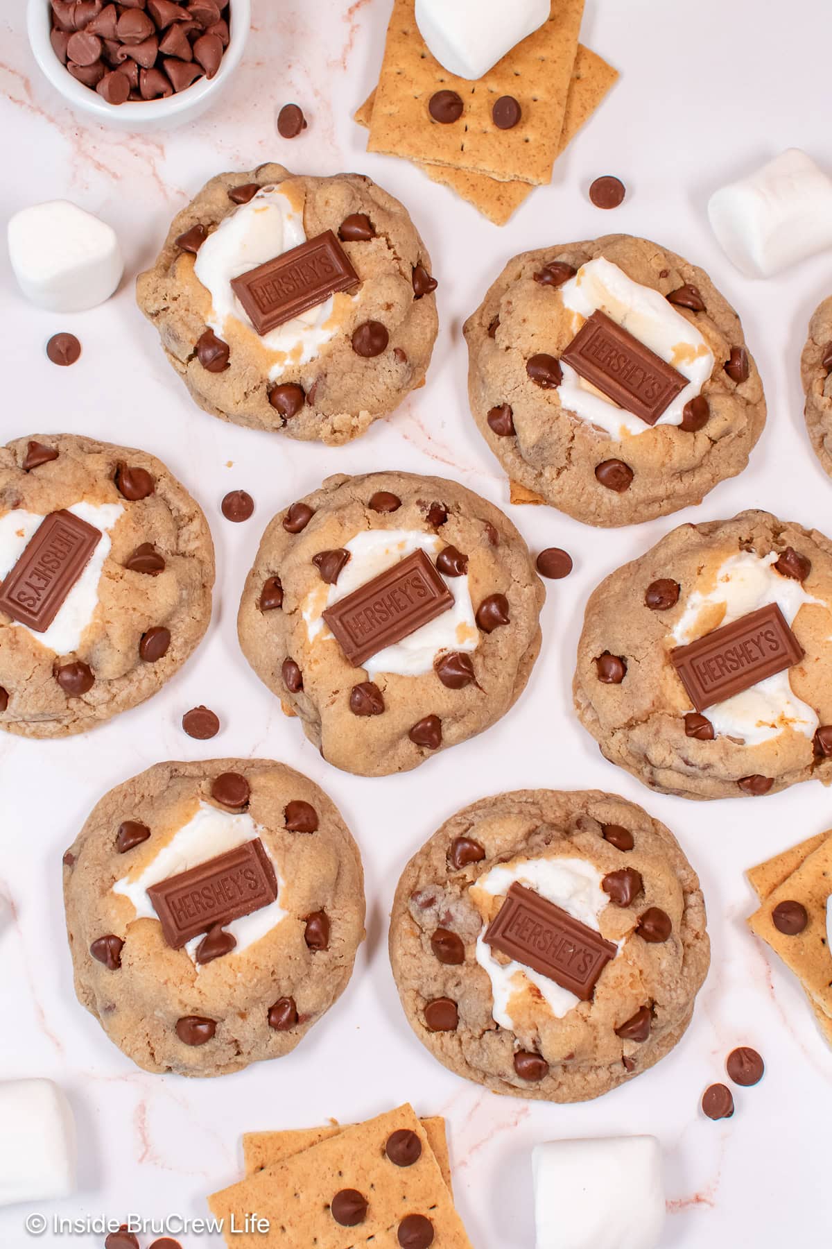 A white board with marshmallow stuffed cookies on it.