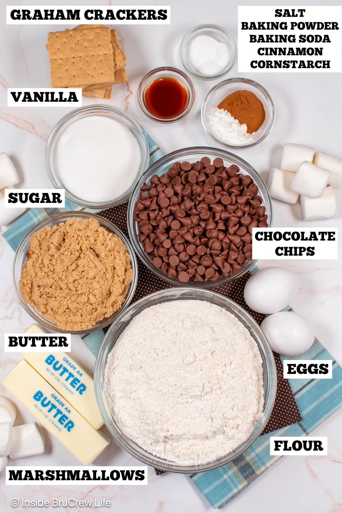 Bowls of ingredients needed to make chocolate chip cookies with marshmallows.