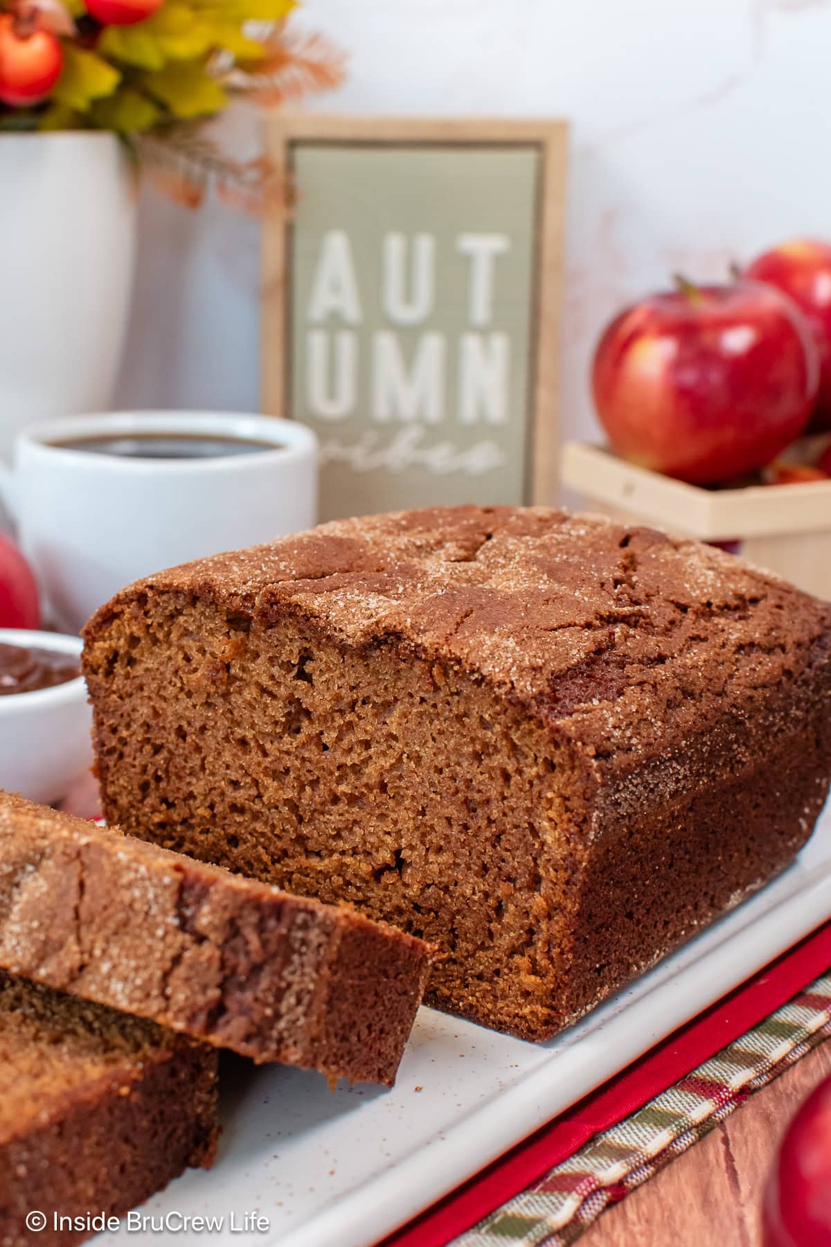 A loaf of apple butter bread on a white plate.