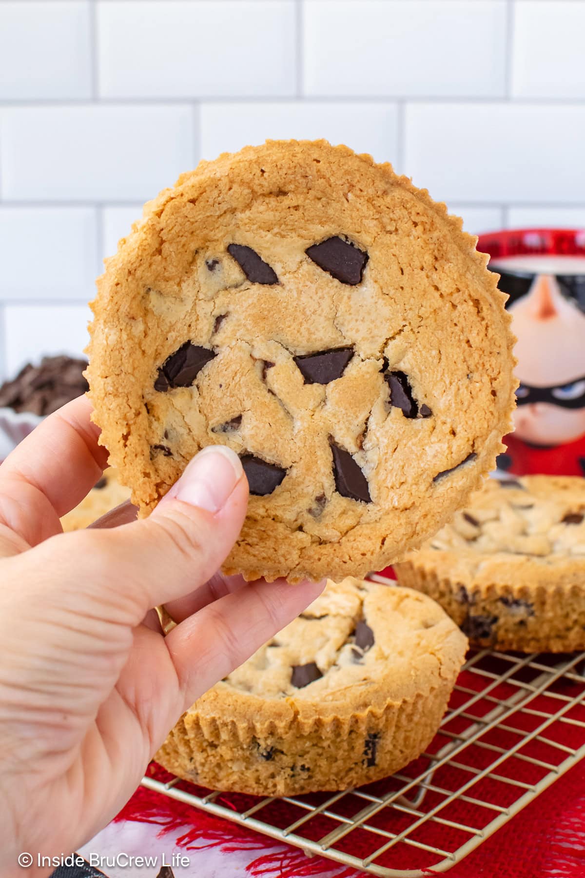 A large num num cookie being held in the air.