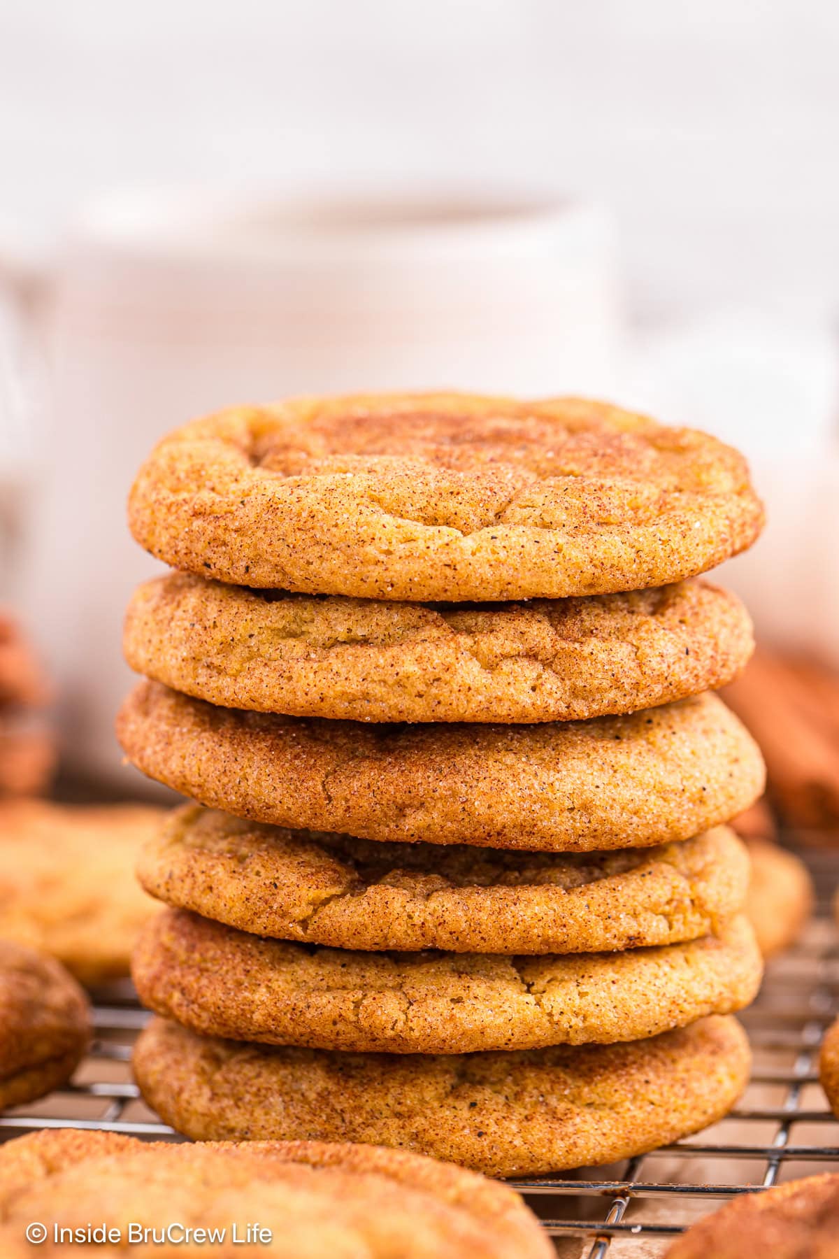 Six fall cookies stacked on a wire rack.