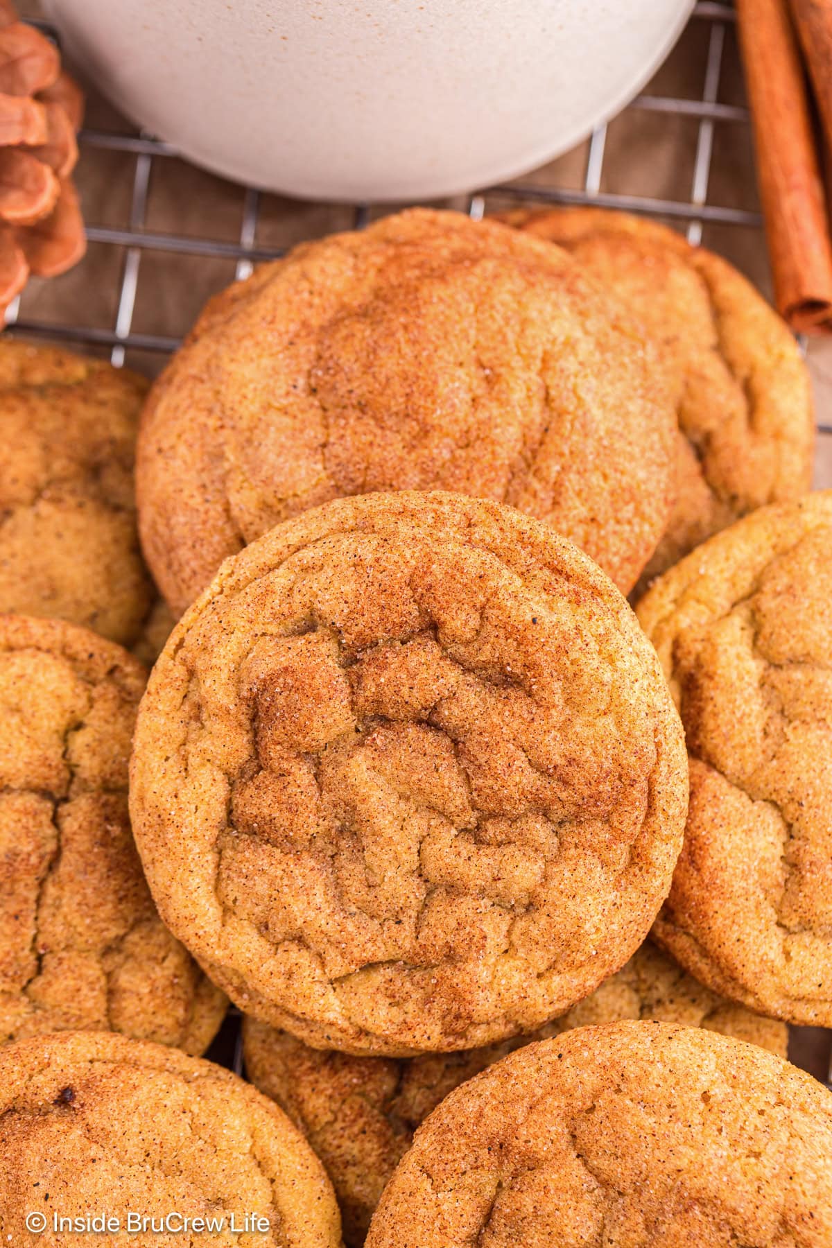 Cinnamon sugar coated pumpkin cookies stacked on a tray.