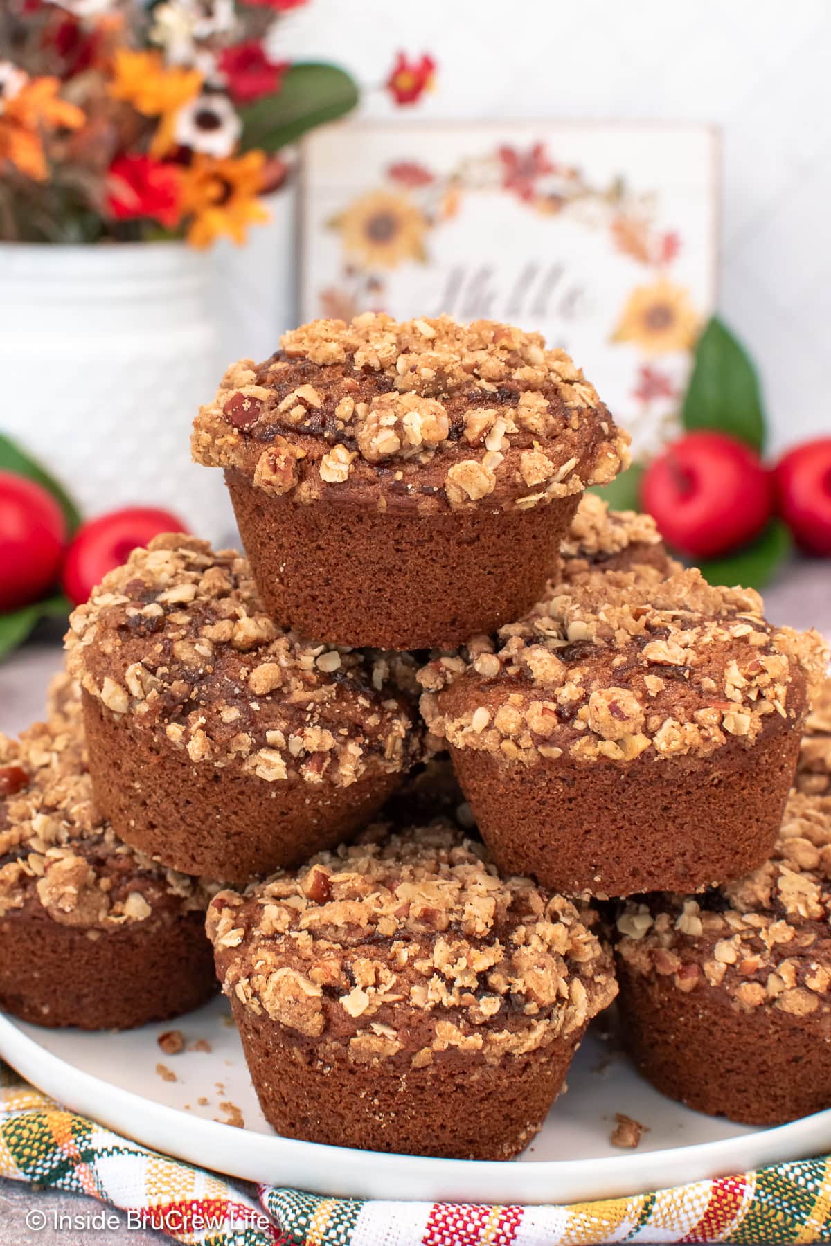 A pile of muffins on a white plate.