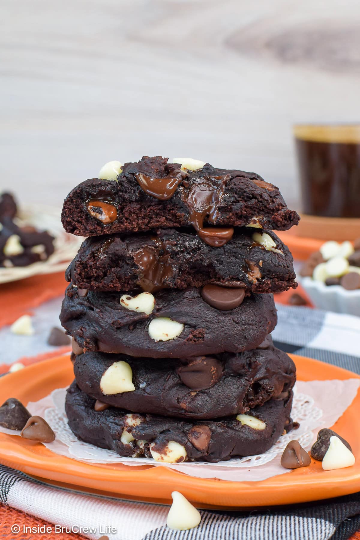 A stack of chocolate pumpkin cookies loaded with chips.