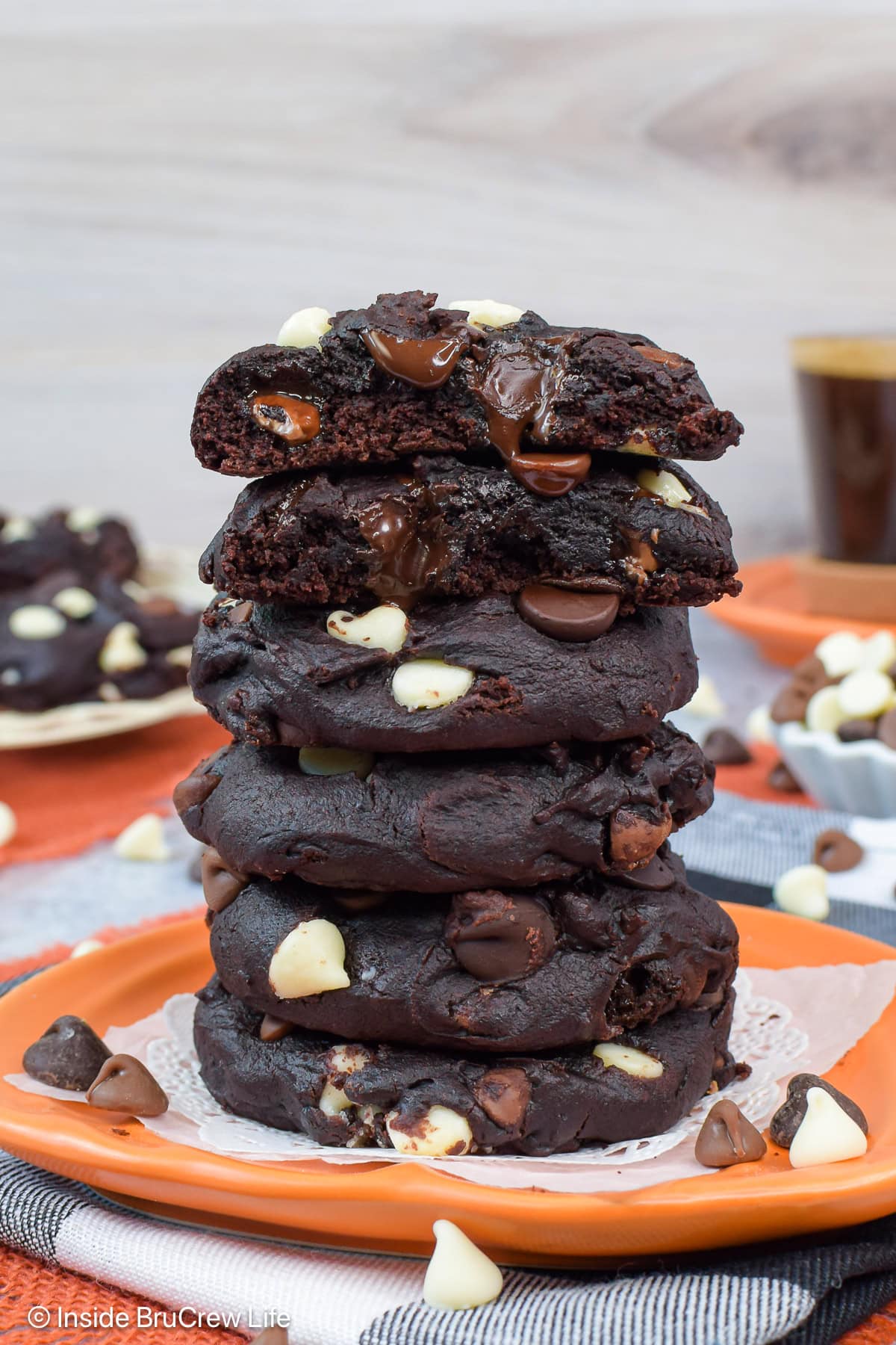 A stack of chocolate cookies packed with triple chocolate chips.