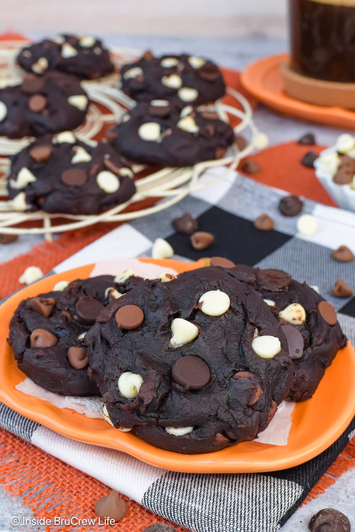 Pumpkin cocoa cookies on an orange plate.