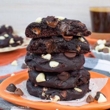 A stack of chocolate pumpkin cookies loaded with chips.